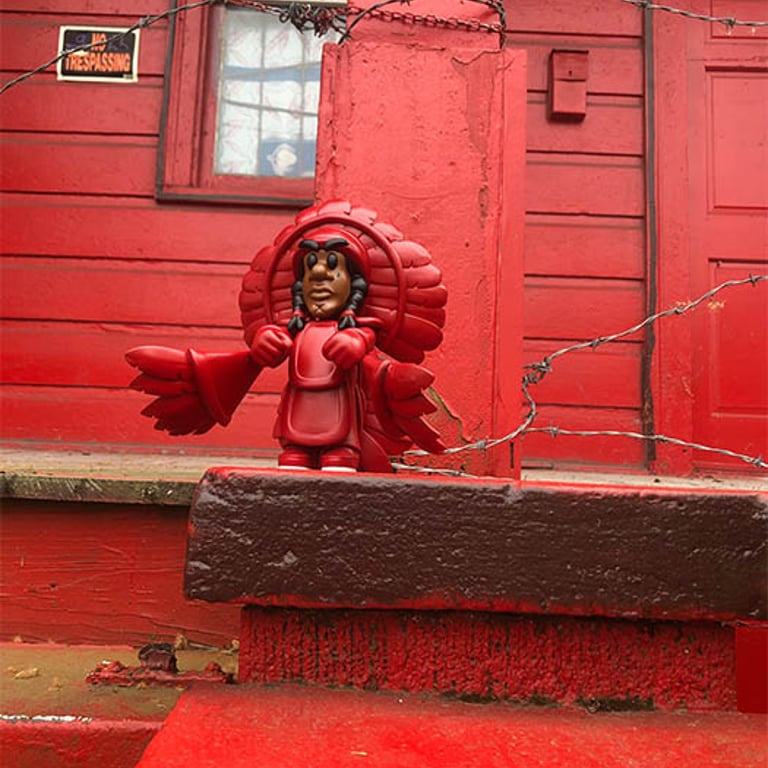 Spy boy in a red suit on the porch in New Orleans, LA