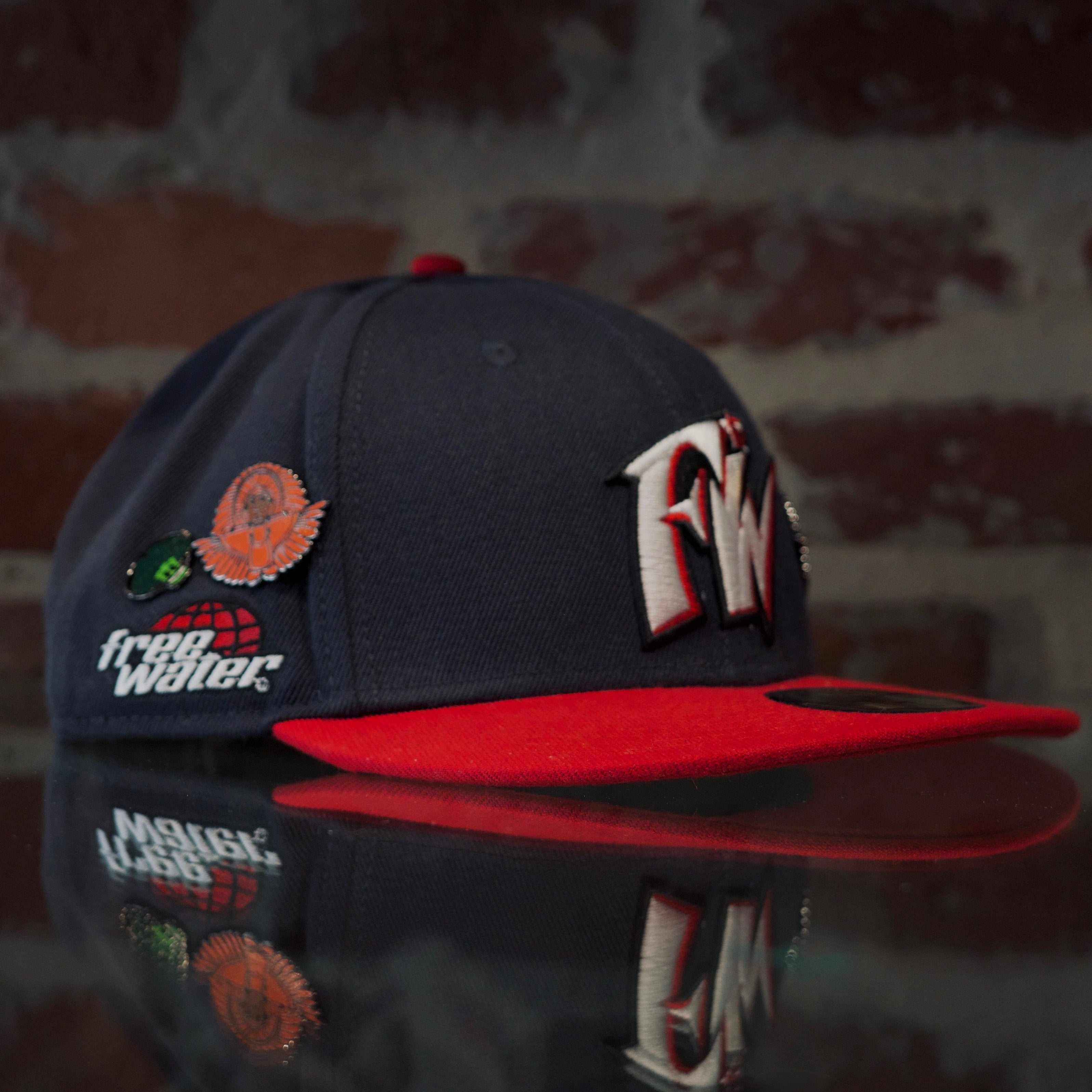 Navy and red free water cap with SPY BOY pin