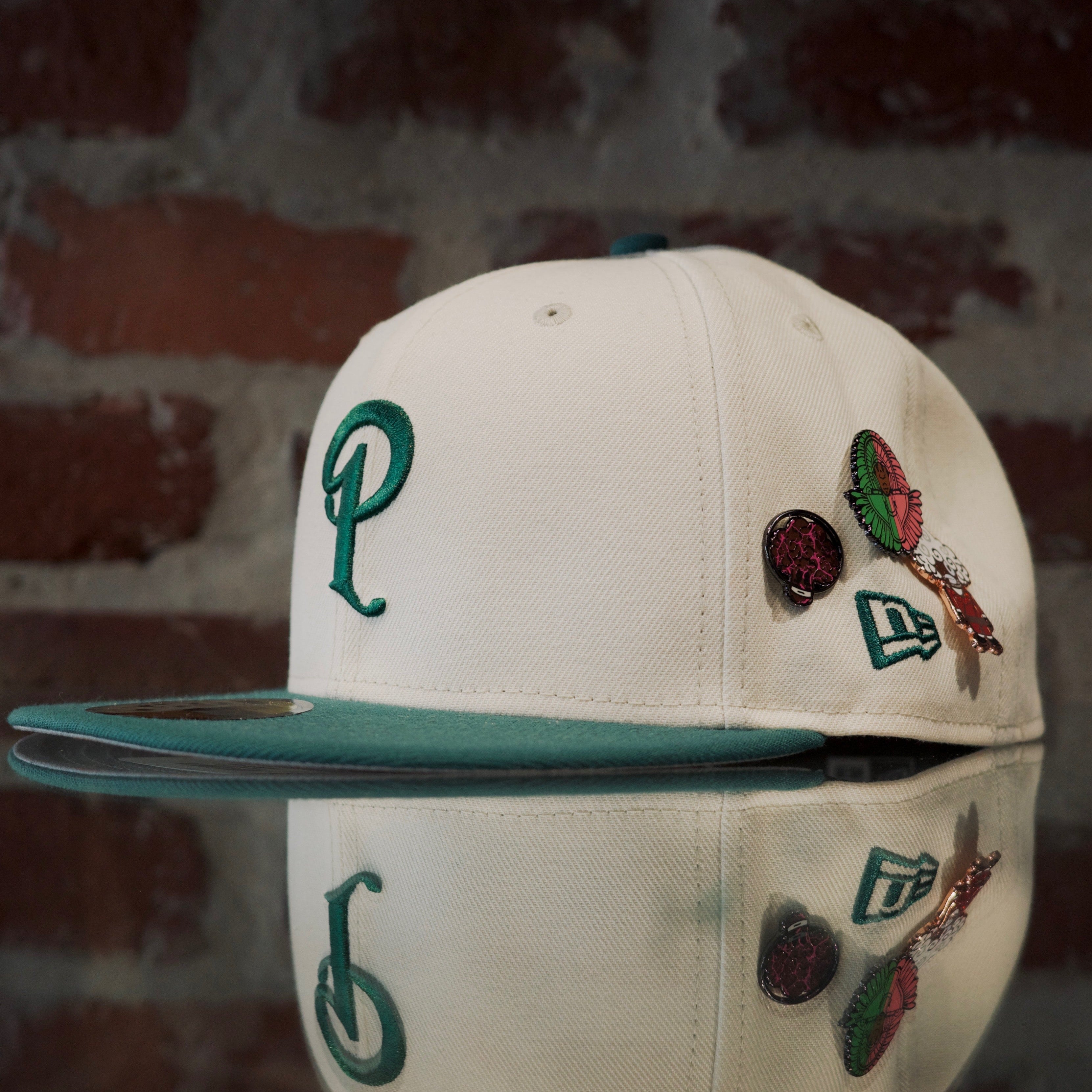 Politics logo cream cap with green logo and various SPY BOY and space broccoli pins