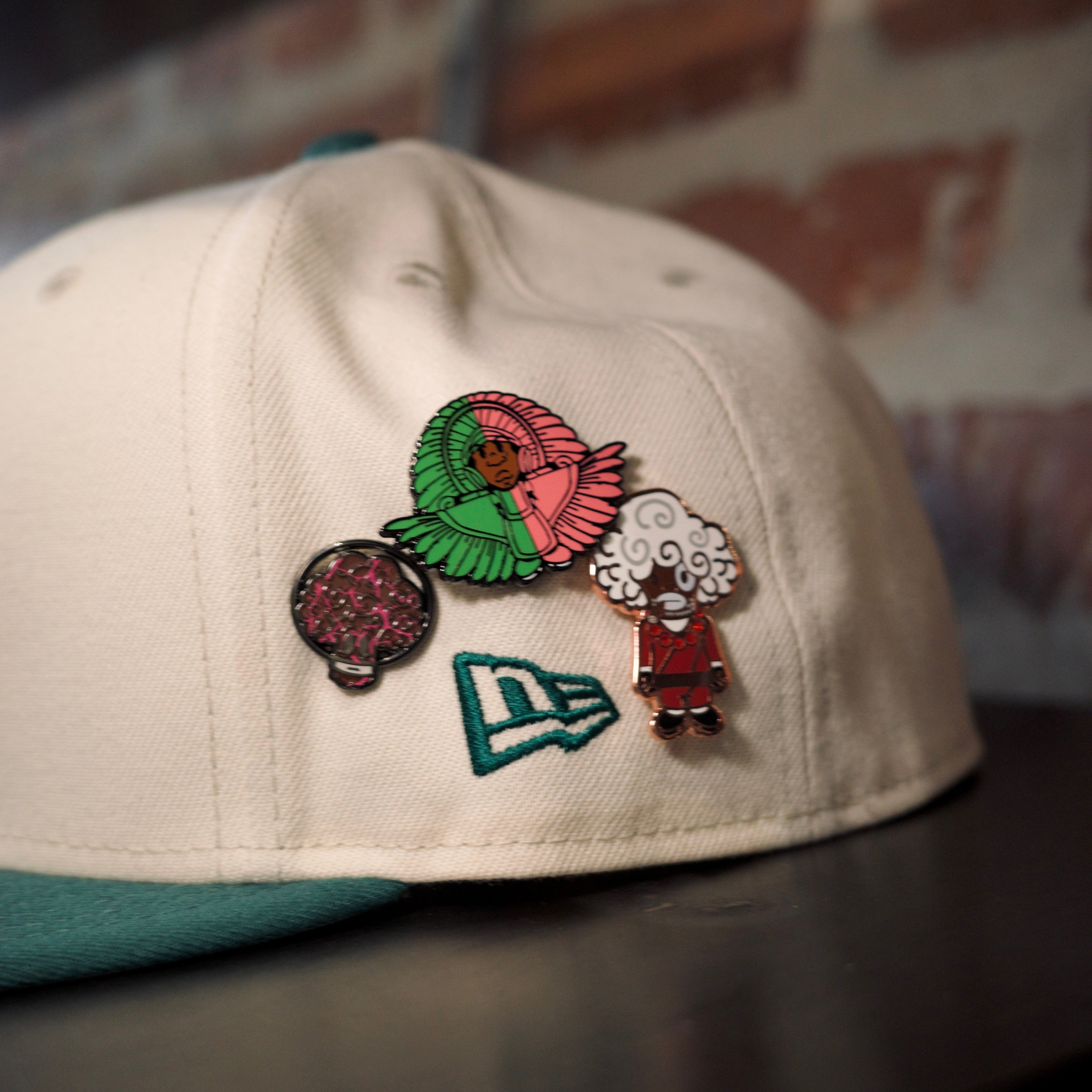 Politics logo cream cap with green logo and various SPY BOY and space broccoli pins